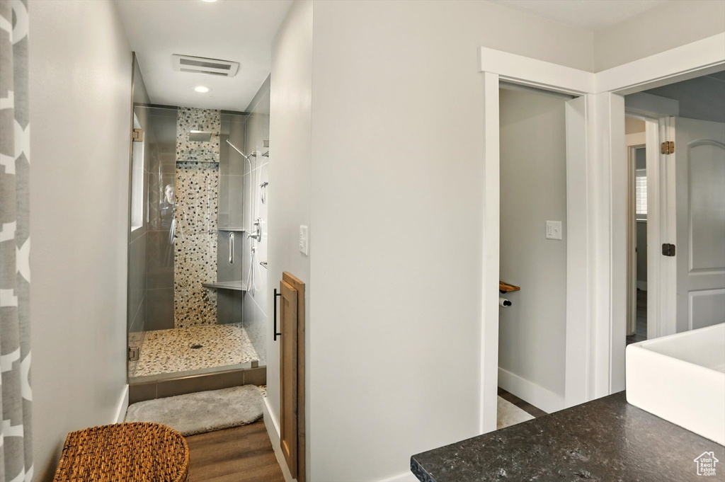 Bathroom featuring baseboards, a shower stall, visible vents, and recessed lighting