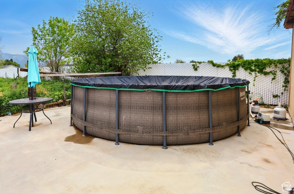 View of pool featuring a patio, fence, and a fenced in pool