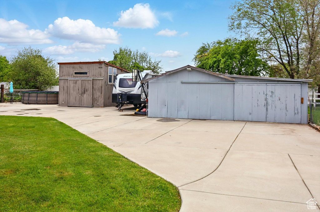 View of patio featuring a storage shed and an outbuilding