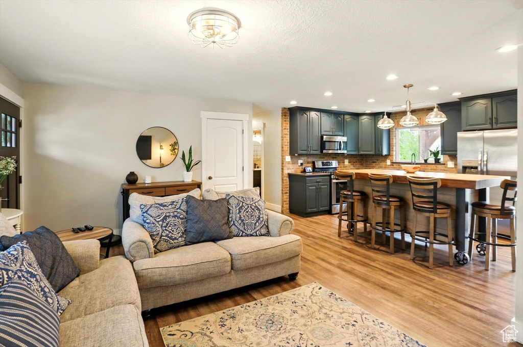 Living room featuring light wood-style flooring and recessed lighting