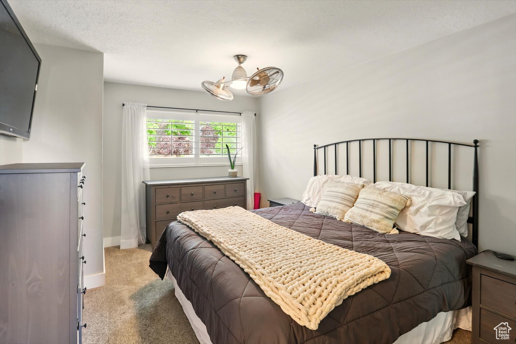 Bedroom with light carpet and baseboards