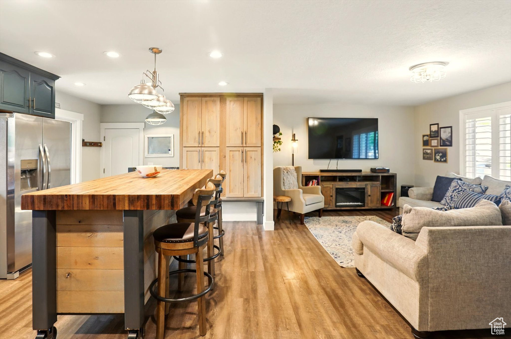 Living area with recessed lighting and light wood-type flooring