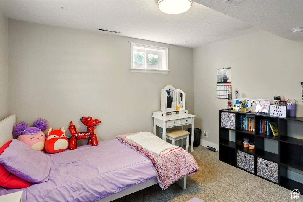 Carpeted bedroom with visible vents