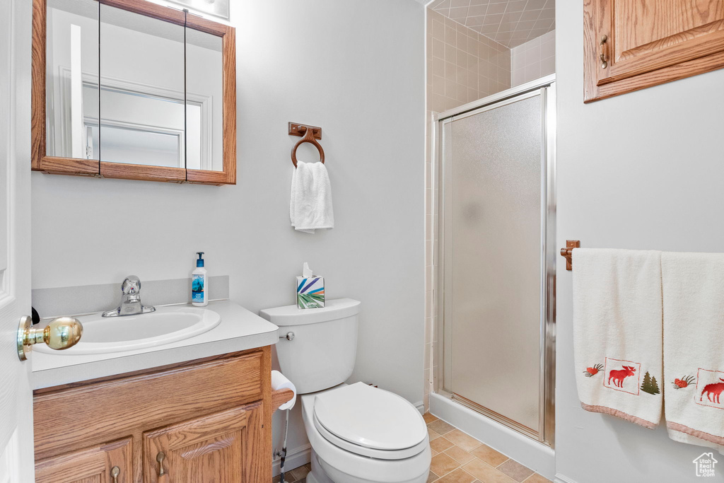 Bathroom with vanity, toilet, and a shower stall
