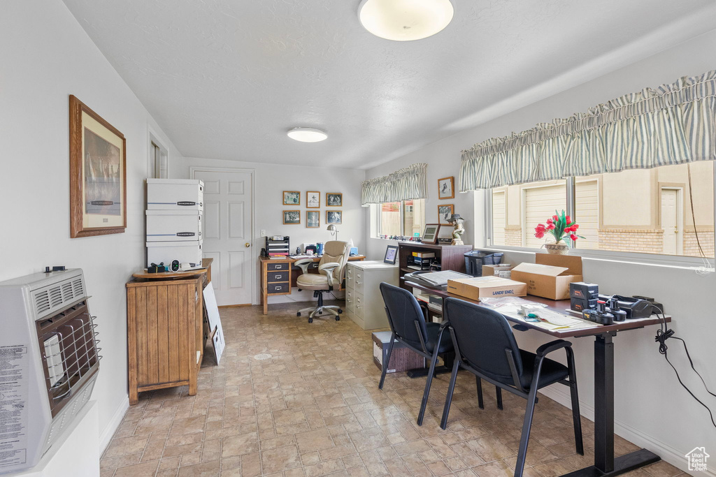 Home office with heating unit and brick floor