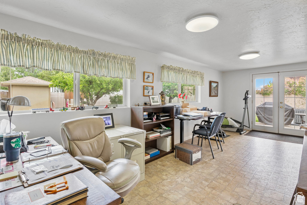 Home office featuring a textured ceiling and french doors