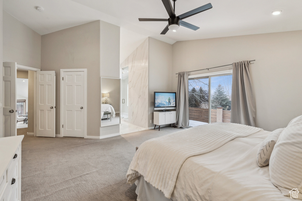 Bedroom featuring baseboards, light carpet, high vaulted ceiling, and a ceiling fan