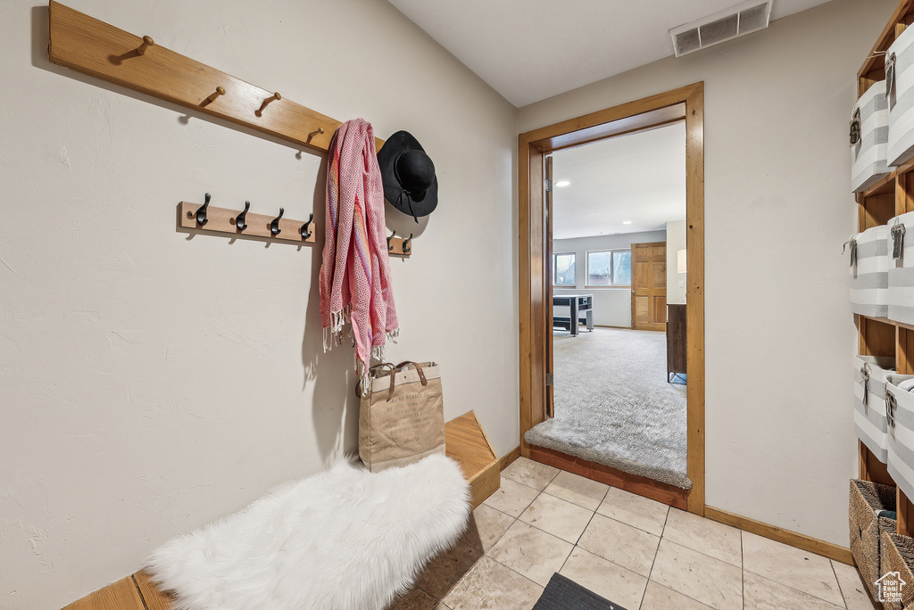 Mudroom with baseboards, light tile patterned floors, and visible vents
