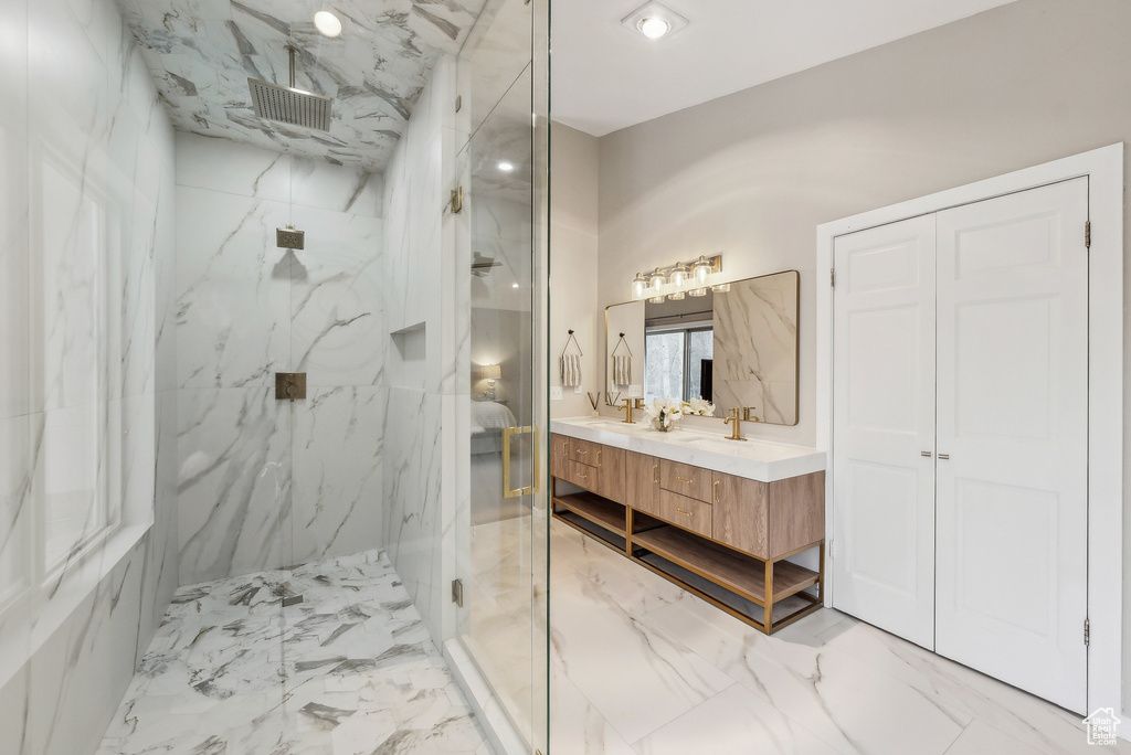 Bathroom featuring vanity, a marble finish shower, marble finish floor, and visible vents