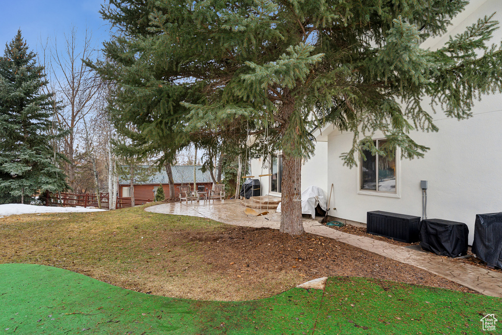 View of yard with a patio area and fence