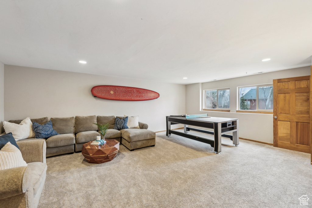 Carpeted living room featuring baseboards and recessed lighting