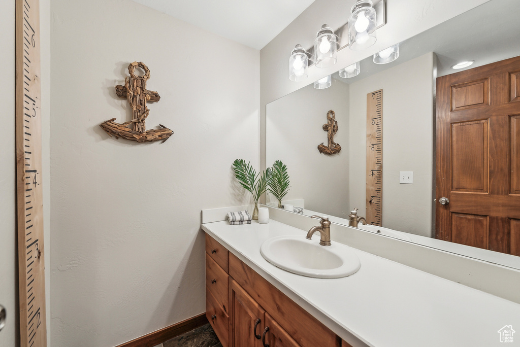 Bathroom featuring vanity and baseboards