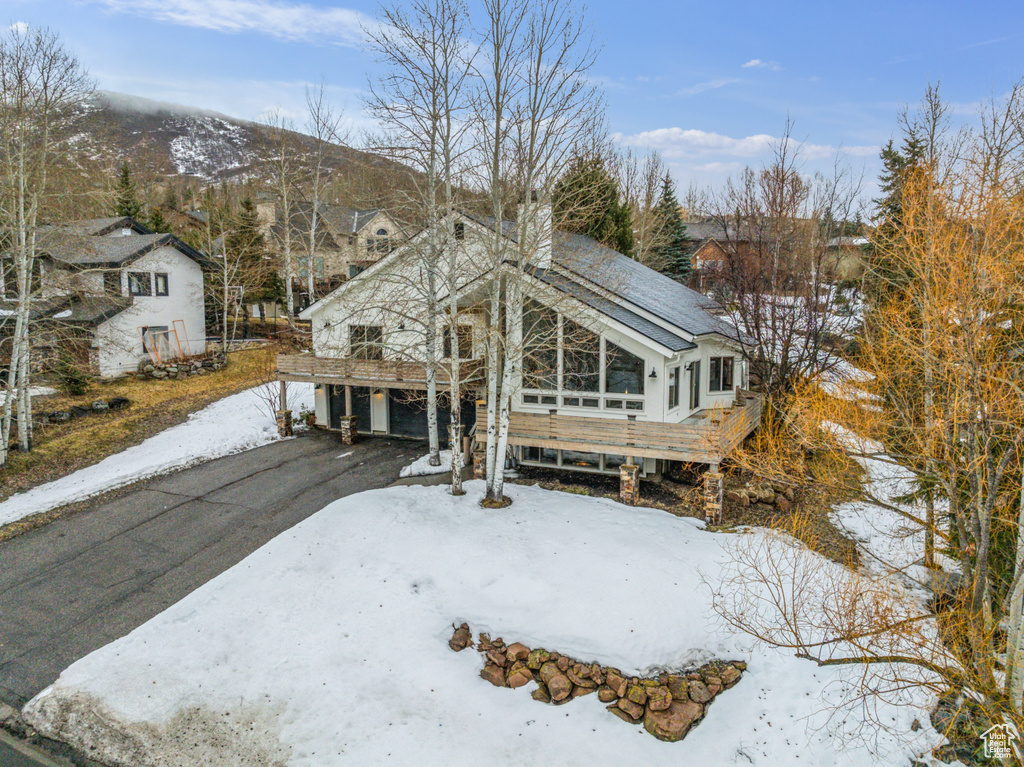 View of front of home featuring a mountain view and driveway
