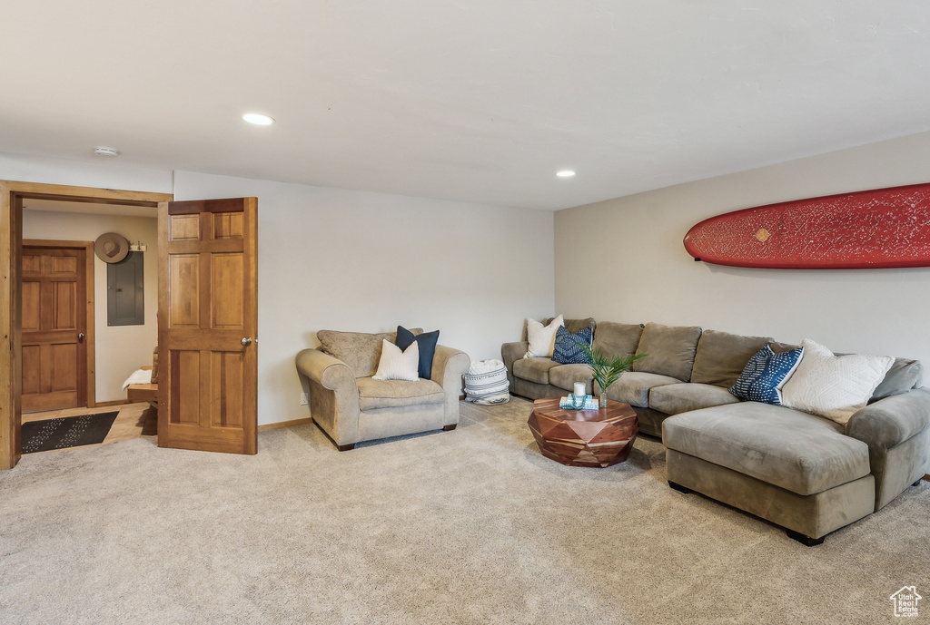 Living area with electric panel, carpet flooring, and recessed lighting