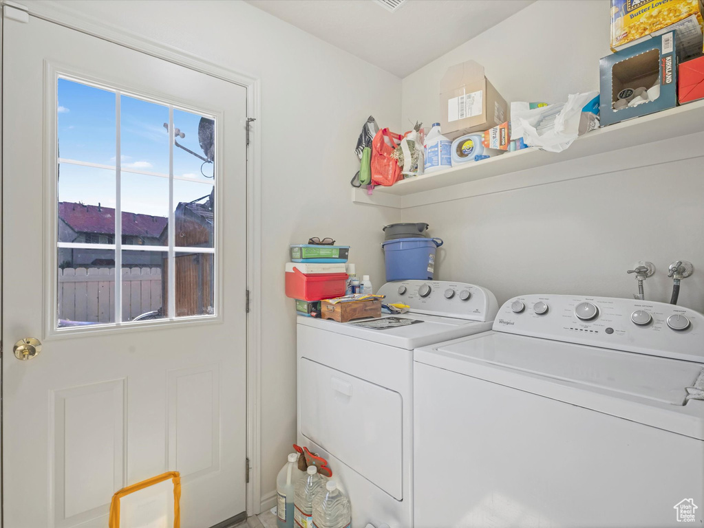 Washroom featuring laundry area and washing machine and dryer
