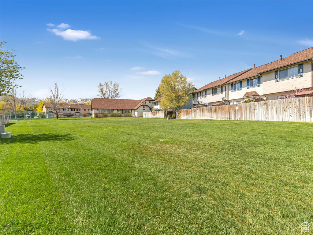 View of yard with fence and a residential view
