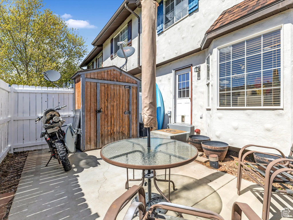 View of patio / terrace featuring a fenced backyard, an outdoor structure, and a shed