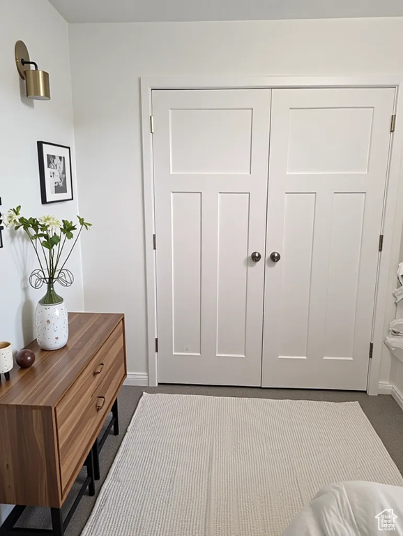 Entryway with dark colored carpet and baseboards