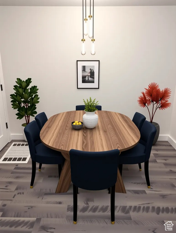 Dining space featuring baseboards and wood finished floors