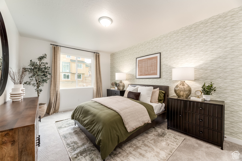 Bedroom featuring light colored carpet and baseboards