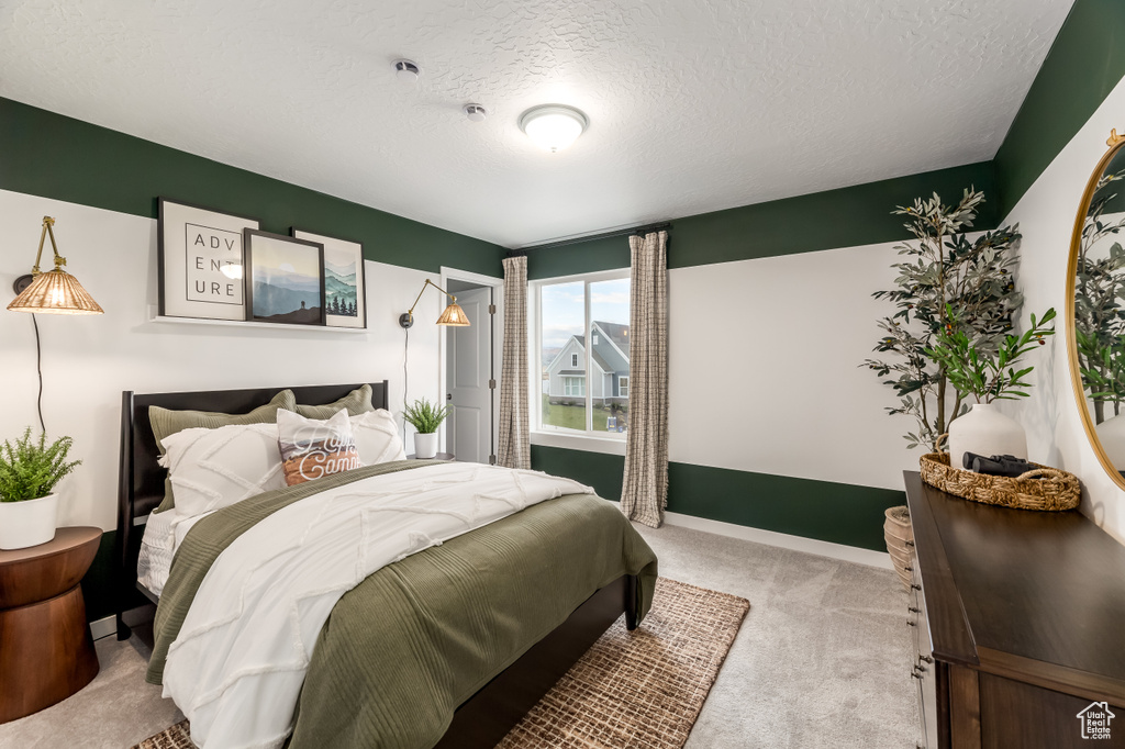 Bedroom featuring a textured ceiling and carpet floors