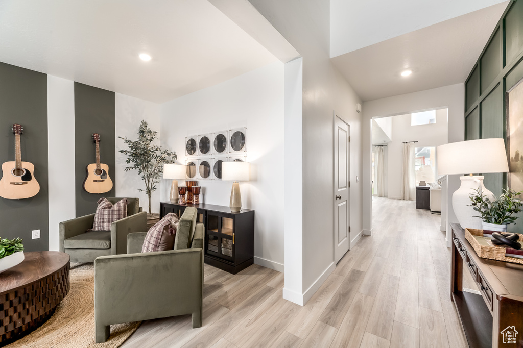 Living area featuring light wood-type flooring, baseboards, and recessed lighting