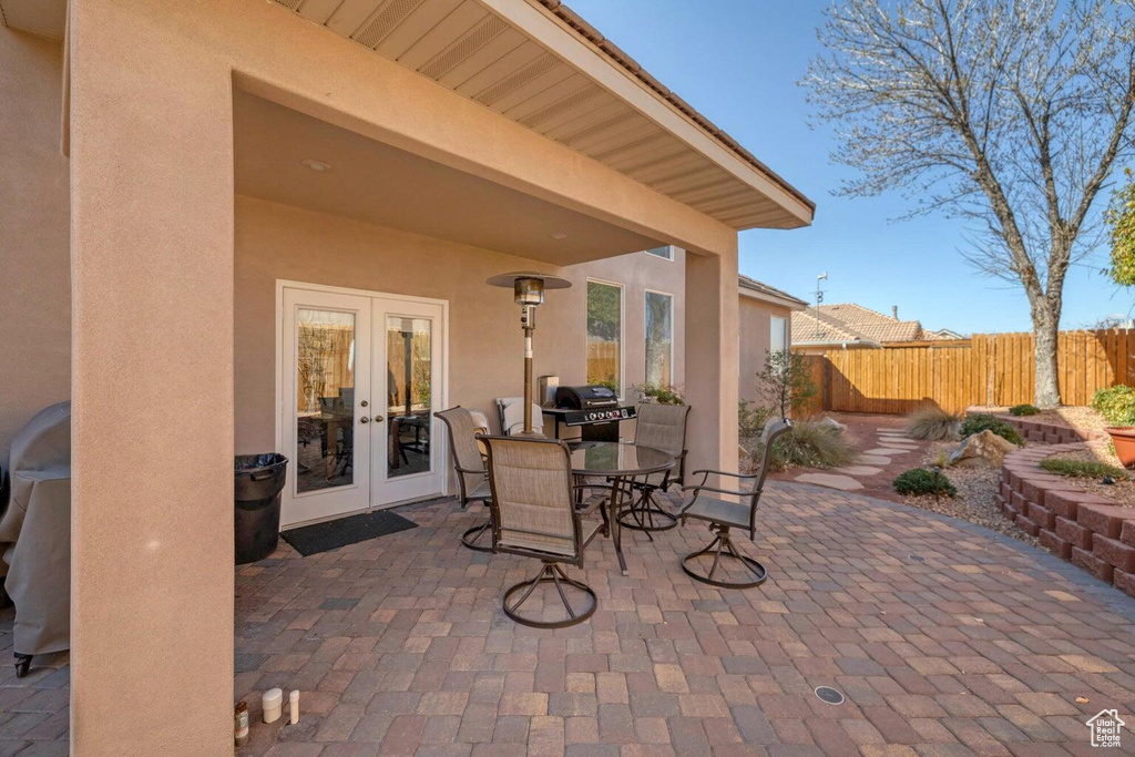 View of patio / terrace with area for grilling, fence, french doors, and outdoor dining space