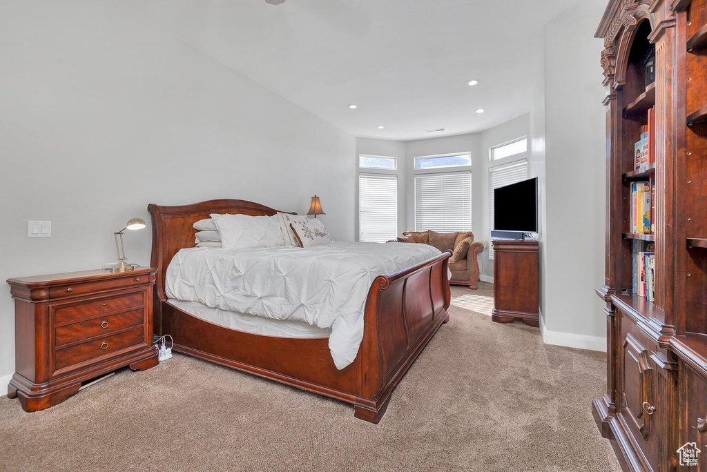 Bedroom with light carpet, baseboards, and recessed lighting