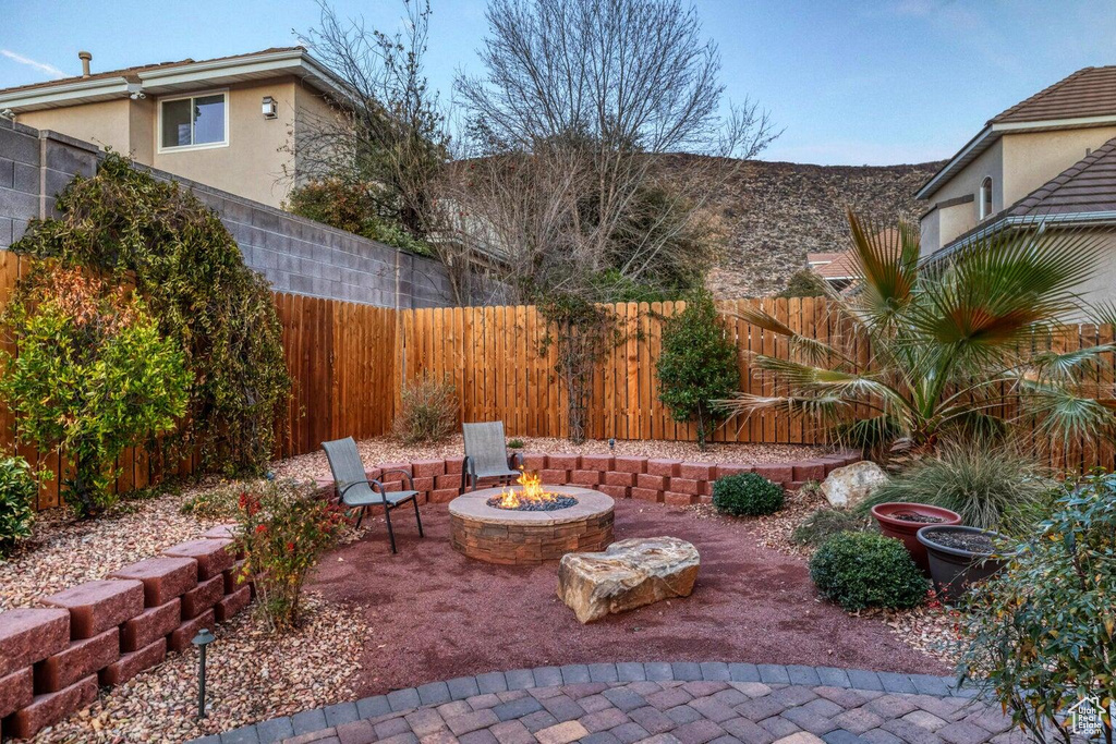 View of patio / terrace with a fire pit and a fenced backyard