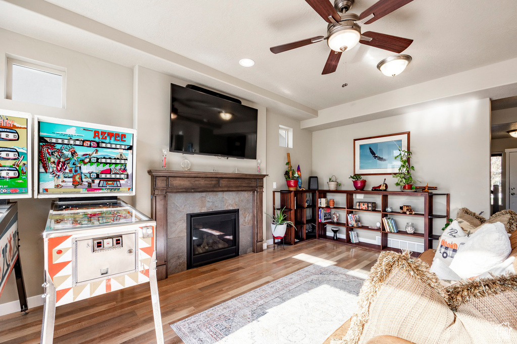 Living area featuring ceiling fan, recessed lighting, a high end fireplace, and wood finished floors