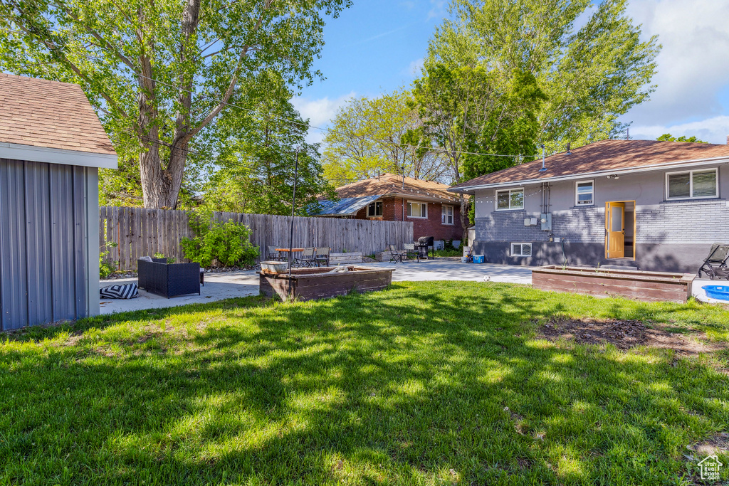View of yard with a patio area and fence