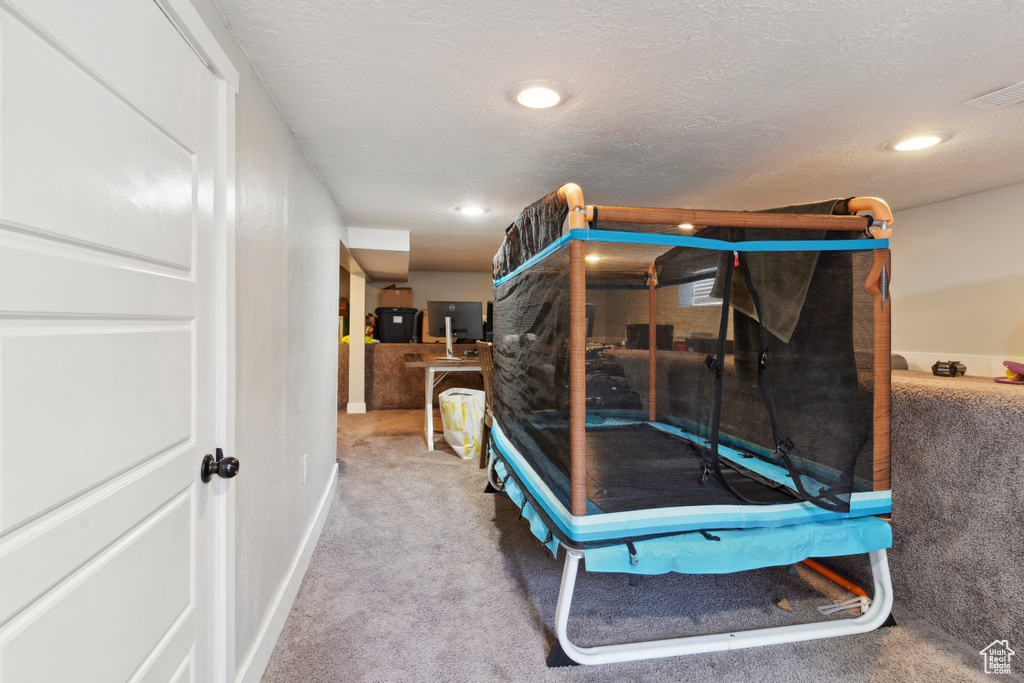 Carpeted bedroom featuring visible vents and recessed lighting
