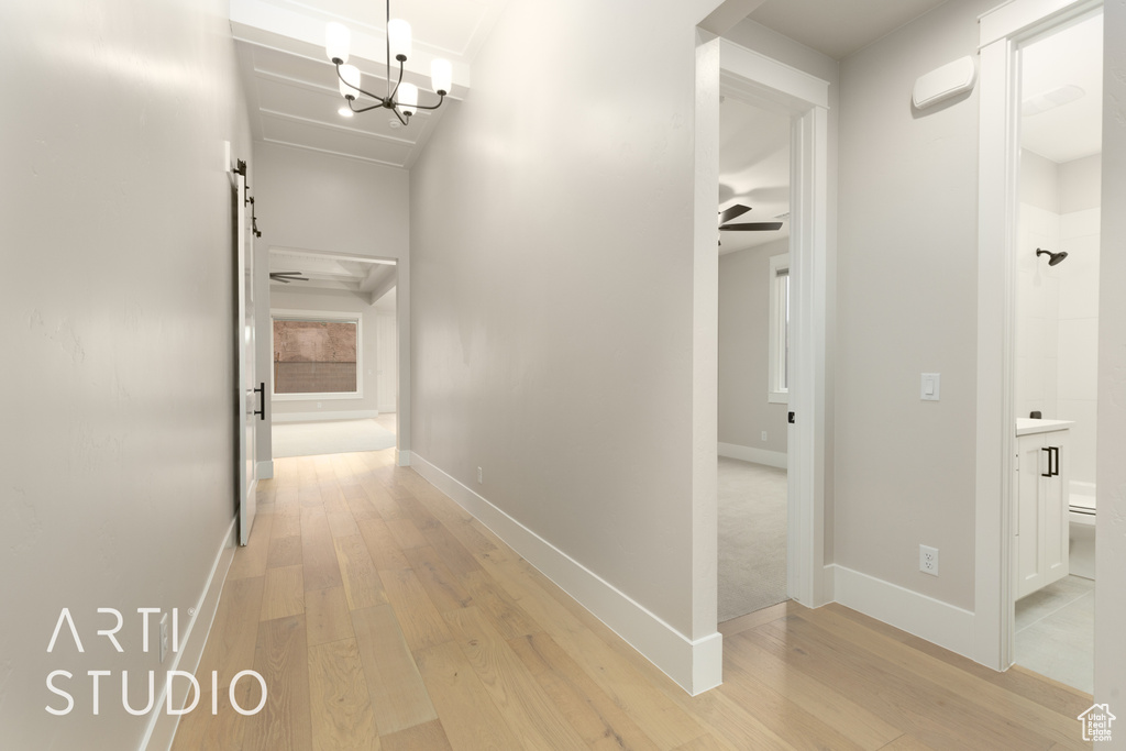 Corridor with light wood finished floors and baseboards