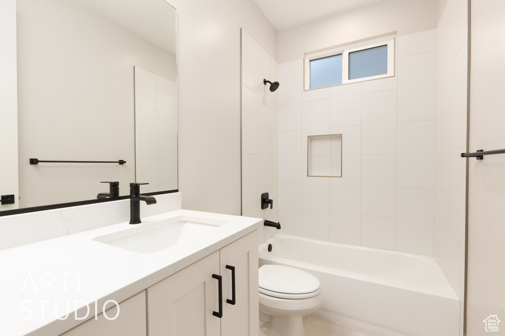 Bathroom with toilet, vanity, and shower / bath combination
