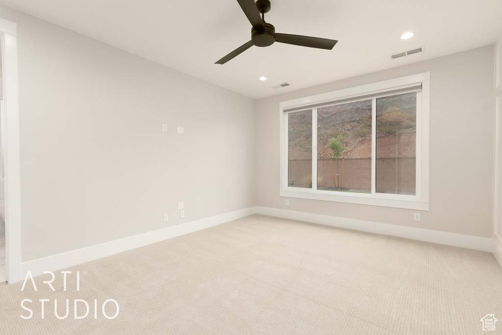 Spare room featuring carpet, recessed lighting, baseboards, and a ceiling fan