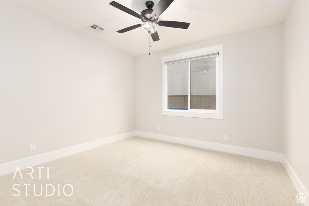 Empty room with carpet floors, baseboards, and a ceiling fan