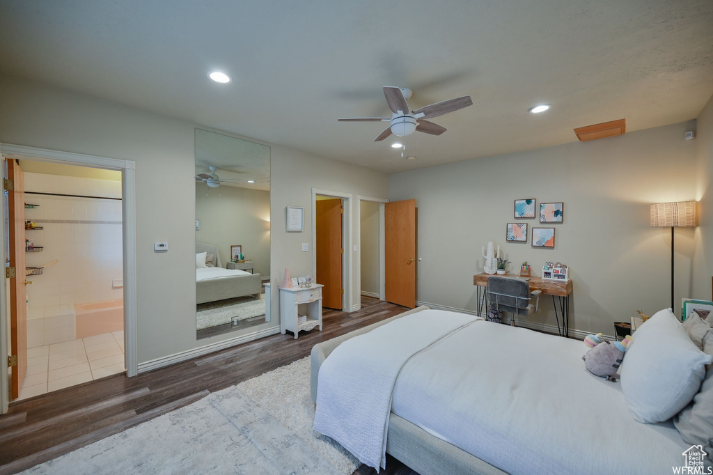 Bedroom with connected bathroom, wood finished floors, a ceiling fan, baseboards, and recessed lighting