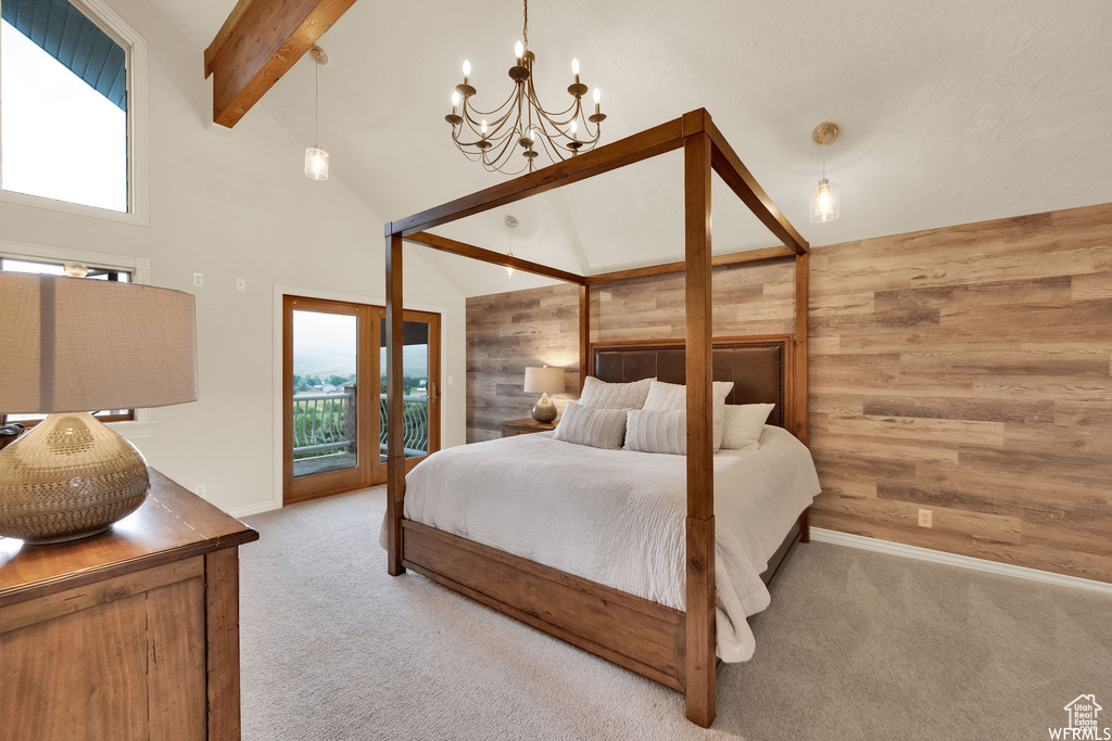Bedroom featuring beamed ceiling, carpet flooring, multiple windows, and a chandelier