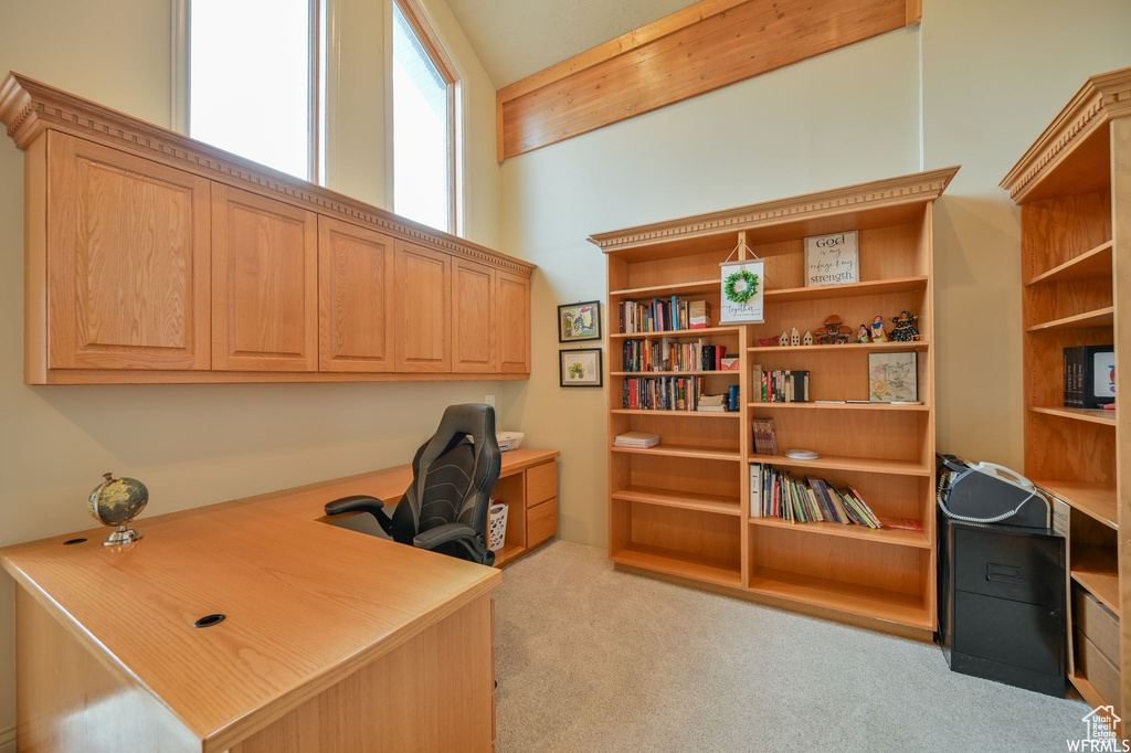 Office space with built in study area and light colored carpet
