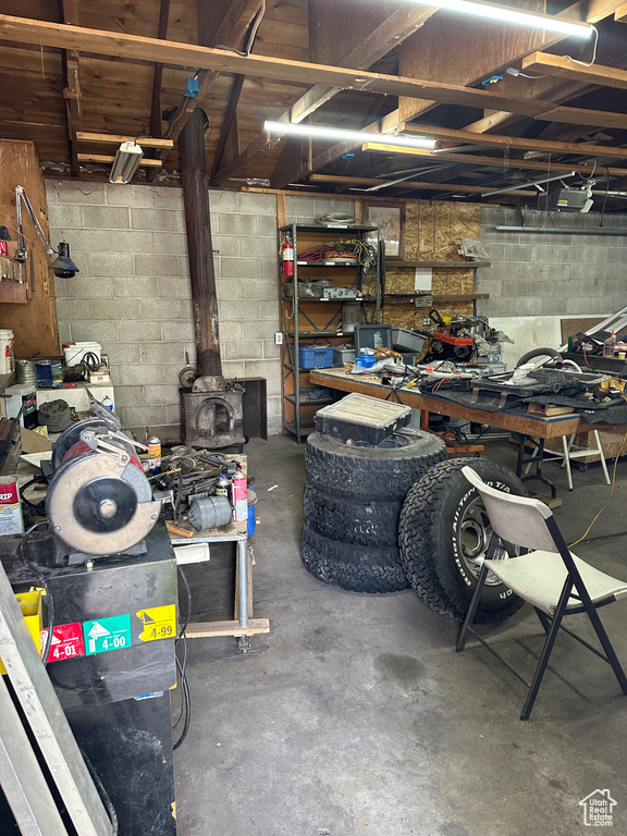 Interior space featuring a workshop area and concrete block wall