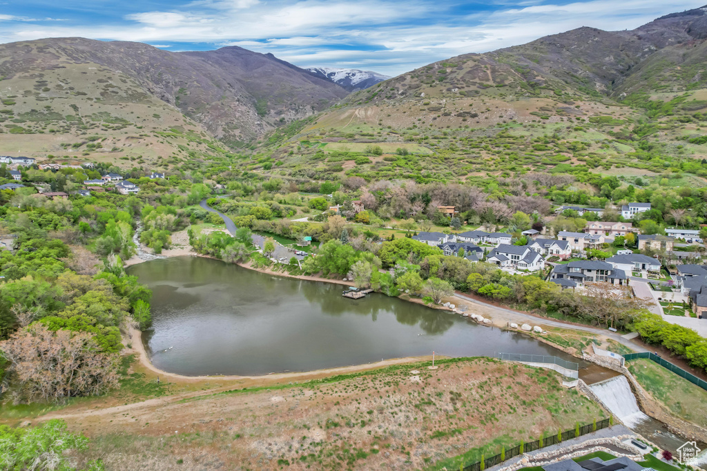 Drone / aerial view featuring a water and mountain view