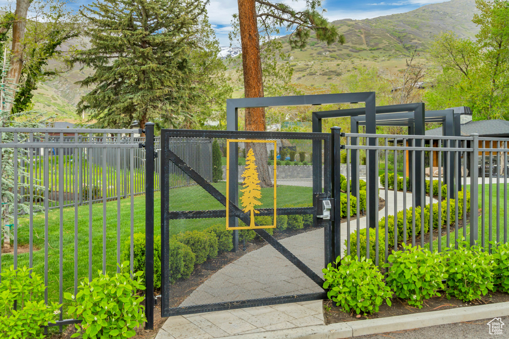 View of gate featuring fence and a mountain view