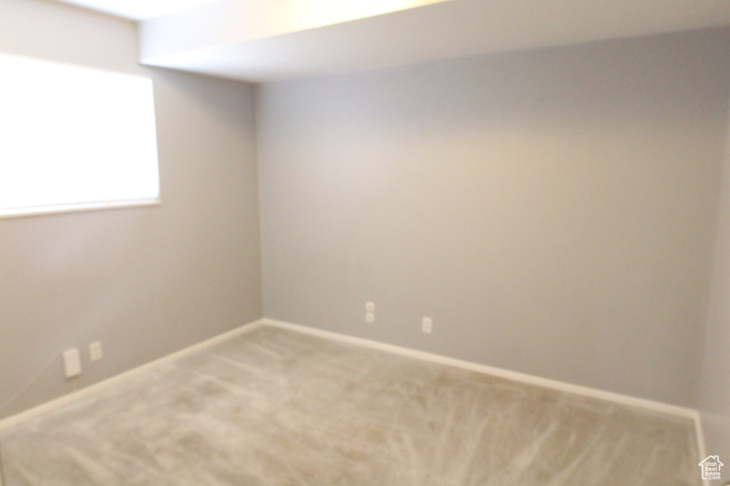 Spare room with light colored carpet and baseboards