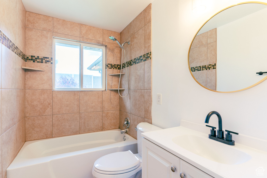 Bathroom with vanity, toilet, and shower / washtub combination