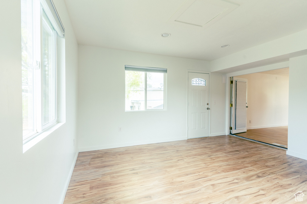 Foyer featuring baseboards and light wood-type flooring