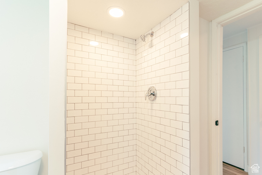 Full bath with a shower stall, recessed lighting, and toilet