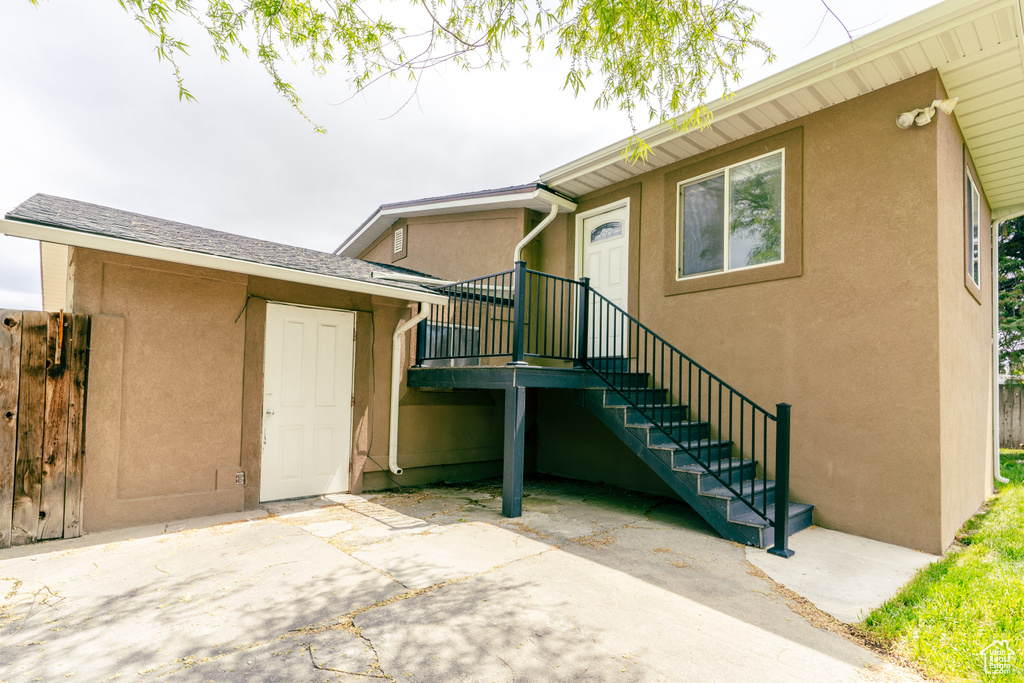 Entrance to property with a patio and stucco siding