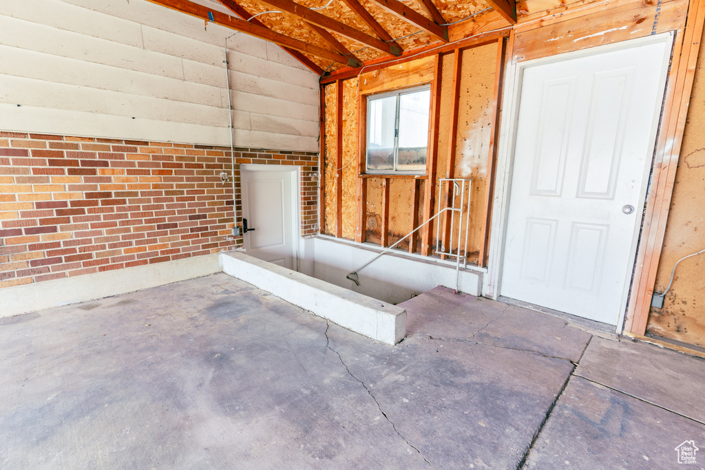 Exterior space featuring unfinished concrete flooring