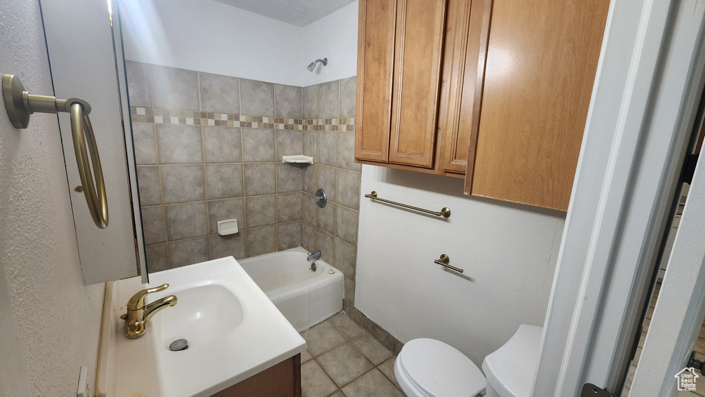 Full bathroom with tile patterned floors, toilet, tub / shower combination, and vanity