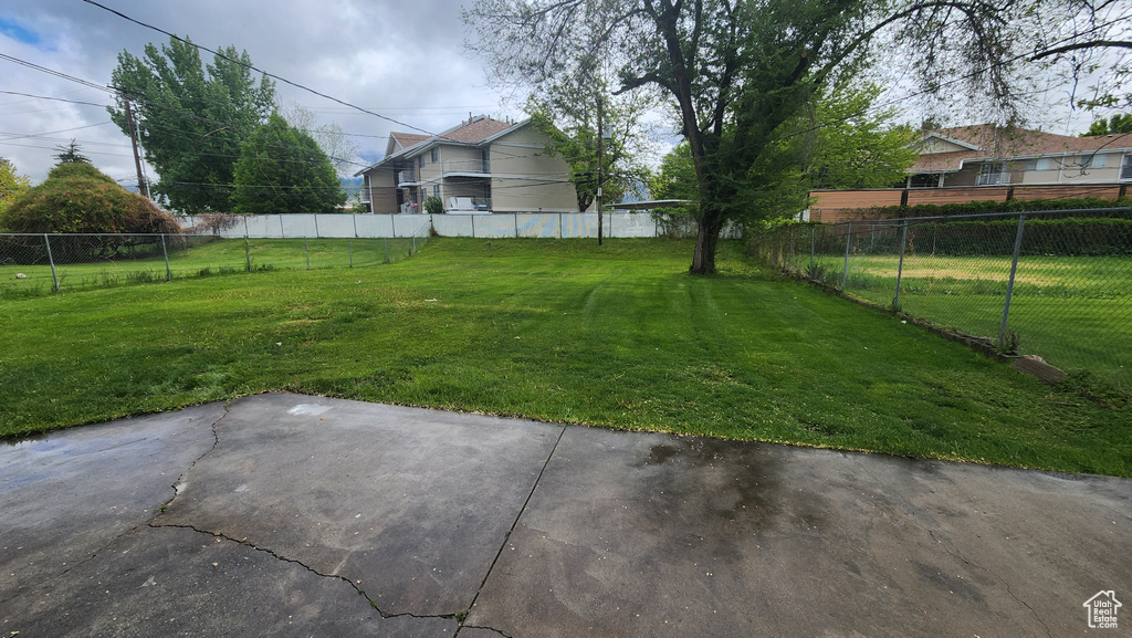 View of yard with a patio area and fence